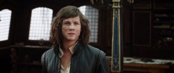 Movie still from “The Three Musketeers” (2011), directed by Paul W.S. Anderson – A man with long brown hair wearing a leather jacket; Close Up shot, Low angle