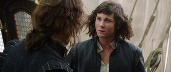 Movie still from “The Three Musketeers” (2011), directed by Paul W.S. Anderson – A man with long hair is talking to another man; Close Up shot, Over the shoulder angle