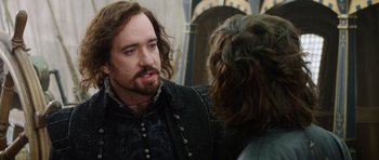 Movie still from “The Three Musketeers” (2011), directed by Paul W.S. Anderson – A man with long hair talking to another man; Close Up shot, Over the shoulder angle