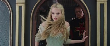 Movie still from “The Three Musketeers” (2011), directed by Paul W.S. Anderson – A woman in a green dress with long blonde hair; Close Up shot, Over the shoulder angle