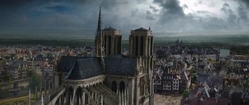 Movie still from “The Three Musketeers” (2011), directed by Paul W.S. Anderson – An aerial view of a cathedral with a cloudy sky above it; Extreme Wide shot, High angle