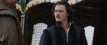 Movie still from “The Three Musketeers” (2011), directed by Paul W.S. Anderson – A person with long black hair; Close Up shot, Over the shoulder angle