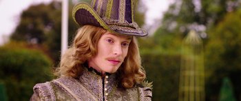 Movie still from “The Three Musketeers” (2011), directed by Paul W.S. Anderson – A person with long hair wearing a hat; Close Up shot, Over the shoulder angle