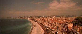 Movie still from “The Transporter” (2002), directed by Corey Yuen – An aerial view of a beach and a city; Extreme Wide shot, High angle