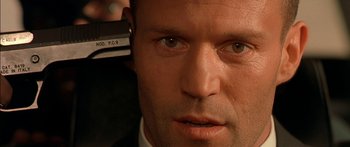 Movie still from “The Transporter” (2002), directed by Corey Yuen – A person with a hair dryer on; Close Up shot, High angle