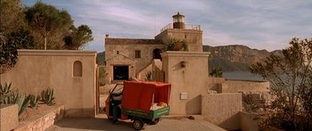 Movie still from “The Transporter” (2002), directed by Corey Yuen – An orange and green three wheeled vehicle with a box on the back of it; Extreme Wide shot, Low angle