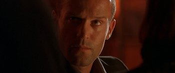 Movie still from “The Transporter” (2002), directed by Corey Yuen – A man's face in a dark room; Close Up shot, Low angle