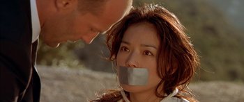 Movie still from “The Transporter” (2002), directed by Corey Yuen – A man and a woman with duct tape on their mouths; Close Up shot, Low angle