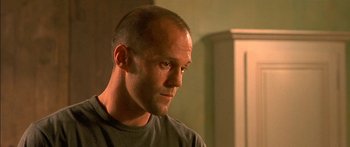 Movie still from “The Transporter” (2002), directed by Corey Yuen – A man with a shaved head looking to his left; Close Up shot, Low angle