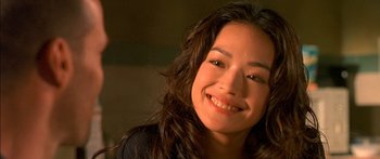 Movie still from “The Transporter” (2002), directed by Corey Yuen – A person smiling for the camera; Close Up shot, High angle