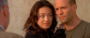 Movie still from “The Transporter” (2002), directed by Corey Yuen – A man and a woman posing for a picture; Close Up shot, Low angle