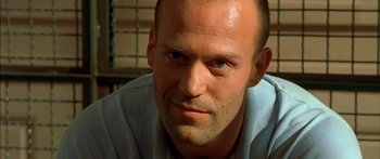 Movie still from “The Transporter” (2002), directed by Corey Yuen – A man's face in a blue shirt; Close Up shot, Low angle