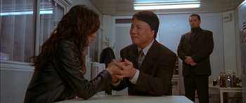 Movie still from “The Transporter” (2002), directed by Corey Yuen – A man and a woman holding hands in a room; Medium shot, Over the shoulder angle