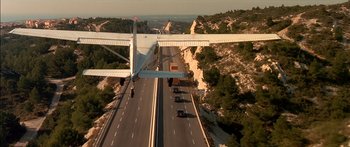 Movie still from “The Transporter” (2002), directed by Corey Yuen – An aerial view of a highway with cars on it; Extreme Wide shot, Low angle