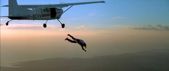 Movie still from “The Transporter” (2002), directed by Corey Yuen – A man in the air with his arms outstreched; Extreme Wide shot, Overhead angle