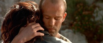 Movie still from “The Transporter” (2002), directed by Corey Yuen – A man and a woman hugging each other outside; Close Up shot, Low angle