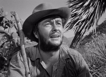 Movie still from “The Treasure of the Sierra Madre” (1948), directed by John Huston – An old black and white photo of a man with a hat; Close Up shot, Low angle
