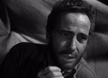Movie still from “The Treasure of the Sierra Madre” (1948), directed by John Huston – Black and white photograph of a man with a beard; Close Up shot, Low angle