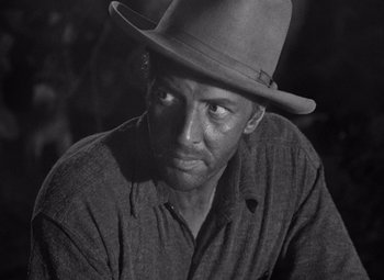 Movie still from “The Treasure of the Sierra Madre” (1948), directed by John Huston – A man wearing a hat is looking at the camera; Close Up shot, Low angle
