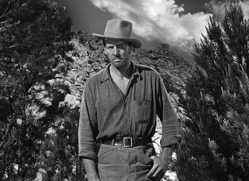 Movie still from “The Treasure of the Sierra Madre” (1948), directed by John Huston – A black and white photo of a man wearing a hat; Medium shot, Low angle