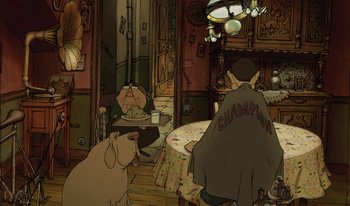 Movie still from “The Triplets of Belleville” (2003), directed by Sylvain Chomet – An animated scene of a man sitting at a dinner table with a dog; Wide shot, High angle