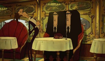 Movie still from “The Triplets of Belleville” (2003), directed by Sylvain Chomet – A group of people sitting around a table; Wide shot, Low angle