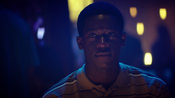 Movie still from “Snowfall” (2017), directed by Hiro Murai – A young man is looking into the camera; Close Up shot, Low angle