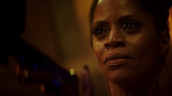 Movie still from “Snowfall” (2017), directed by Hiro Murai – A woman's face in a dark room; Close Up shot, Low angle