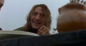 Movie still from “The Village” (2004), directed by M. Night Shyamalan – A person with long brown hair; Close Up shot, Low angle