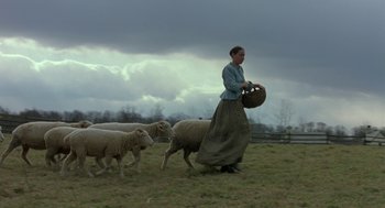 Movie still from “The Village” (2004), directed by M. Night Shyamalan – A woman herding sheep in a field; Wide shot, Low angle