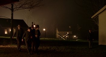 Movie still from “The Village” (2004), directed by M. Night Shyamalan – Two men walking in a field at night; Extreme Wide shot, High angle
