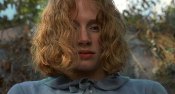 Movie still from “The Village” (2004), directed by M. Night Shyamalan – A person with long blonde hair; Close Up shot, Low angle