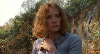 Movie still from “The Village” (2004), directed by M. Night Shyamalan – A woman with long red hair is posing for a picture; Close Up shot, Low angle