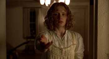 Movie still from “The Village” (2004), directed by M. Night Shyamalan – A woman in a white dress is holding her hand out; Close Up shot, Low angle