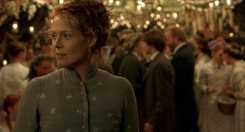 Movie still from “The Village” (2004), directed by M. Night Shyamalan – A woman standing in front of a group of people; Medium shot, Over the shoulder angle