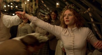Movie still from “The Village” (2004), directed by M. Night Shyamalan – A woman in a white dress and a wreath on her head; Medium shot, Low angle