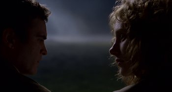 Movie still from “The Village” (2004), directed by M. Night Shyamalan – A man and a woman face to face in the dark; Close Up shot, Low angle