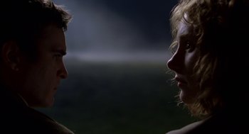 Movie still from “The Village” (2004), directed by M. Night Shyamalan – A man and a woman face to face in the dark; Close Up shot, Over the shoulder angle