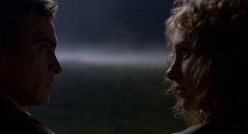 Movie still from “The Village” (2004), directed by M. Night Shyamalan – A man and a woman face to face in the dark; Close Up shot, Over the shoulder angle