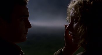 Movie still from “The Village” (2004), directed by M. Night Shyamalan – A man and a woman face to face in the dark; Close Up shot, Low angle