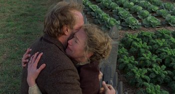 Movie still from “The Village” (2004), directed by M. Night Shyamalan – A man and a woman kissing in a garden; Close Up shot, Low angle