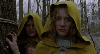 Movie still from “The Village” (2004), directed by M. Night Shyamalan – Two people wearing yellow capes in the woods; Close Up shot, Low angle