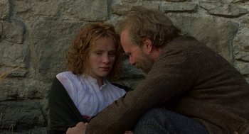 Movie still from “The Village” (2004), directed by M. Night Shyamalan – A man and a woman sitting next to each other; Close Up shot, Over the shoulder angle