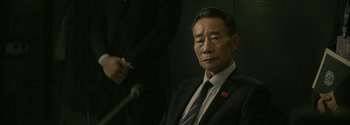Movie still from “The Wandering Earth II” (2023), directed by Frant Gwo – An older man in a suit and tie; Close Up shot, Over the shoulder angle