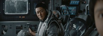 Movie still from “The Wandering Earth II” (2023), directed by Frant Gwo – A man with a helmet on his head; Close Up shot, Over the shoulder angle