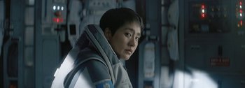 Movie still from “The Wandering Earth II” (2023), directed by Frant Gwo – A young man wearing a space suit looks into the distance; Close Up shot, Over the shoulder angle