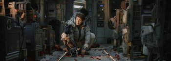 Movie still from “The Wandering Earth II” (2023), directed by Frant Gwo – A man kneeling down on the ground holding a camera; Medium shot, Low angle