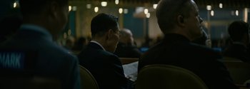 Movie still from “The Wandering Earth II” (2023), directed by Frant Gwo – A man sitting in a chair reading a newspaper; Close Up shot, Over the shoulder angle