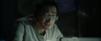Movie still from “The Wandering Earth II” (2023), directed by Frant Gwo – A man wearing glasses and looking at the camera; Close Up shot, Low angle