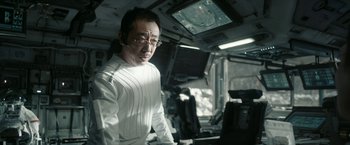 Movie still from “The Wandering Earth II” (2023), directed by Frant Gwo – A man in a white shirt and glasses in an airplane; Medium shot, Over the shoulder angle